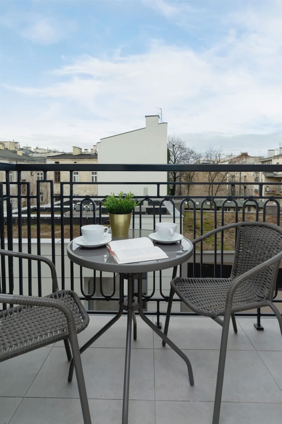 A balcony view featuring a small round table and chairs, perfect for enjoying the outdoors.
