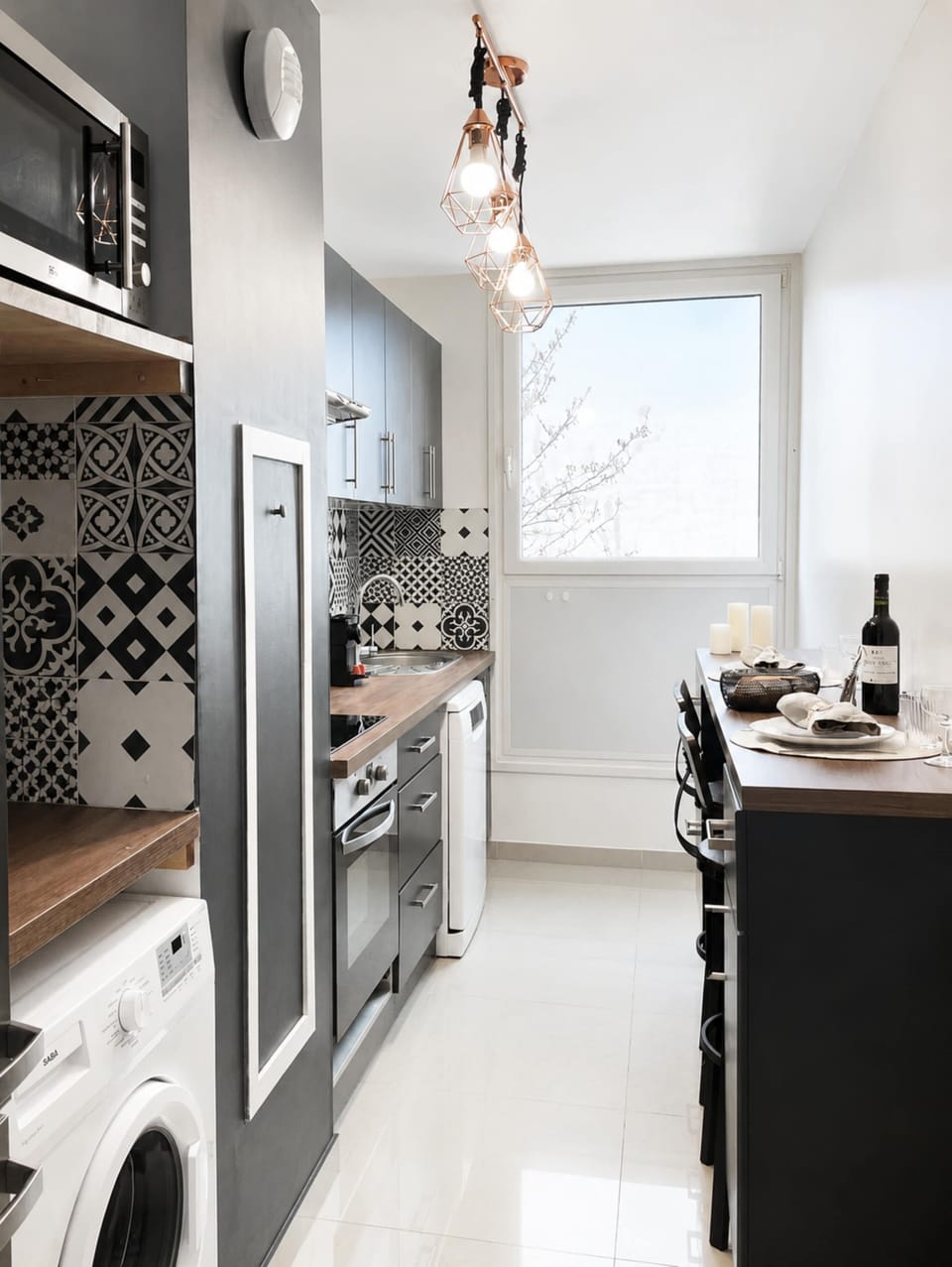 Cosy long dining table in the kitchen, wine bottle included