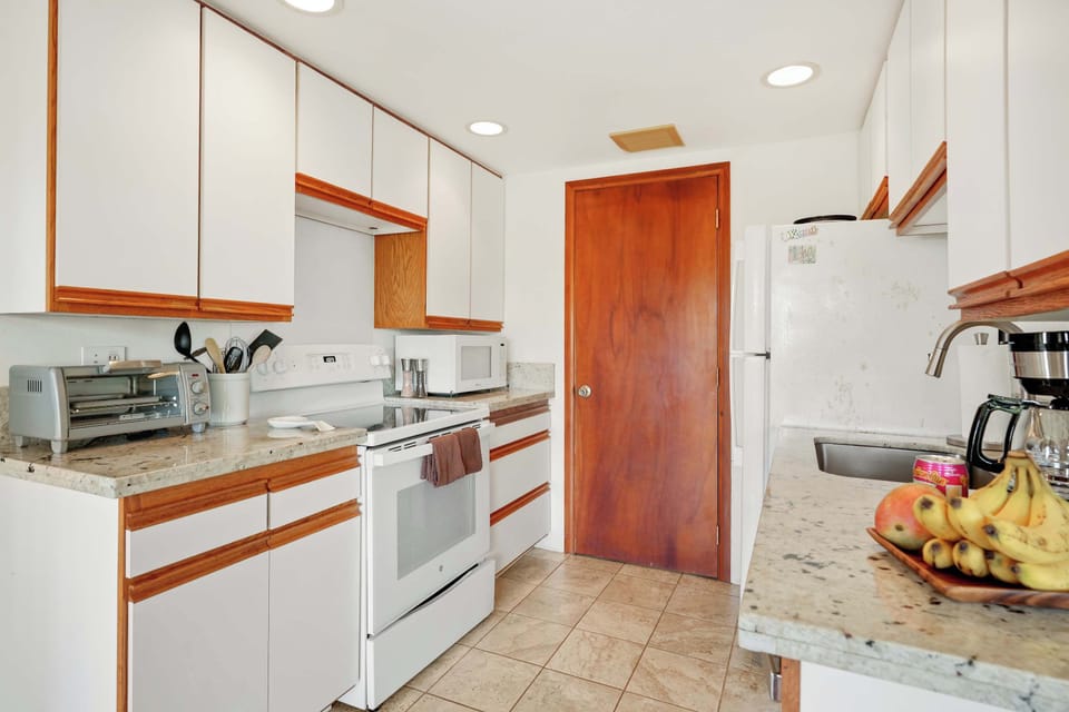 Bright and functional kitchen complete with cookware, dishes, and all the necessities for effortless meals in paradise