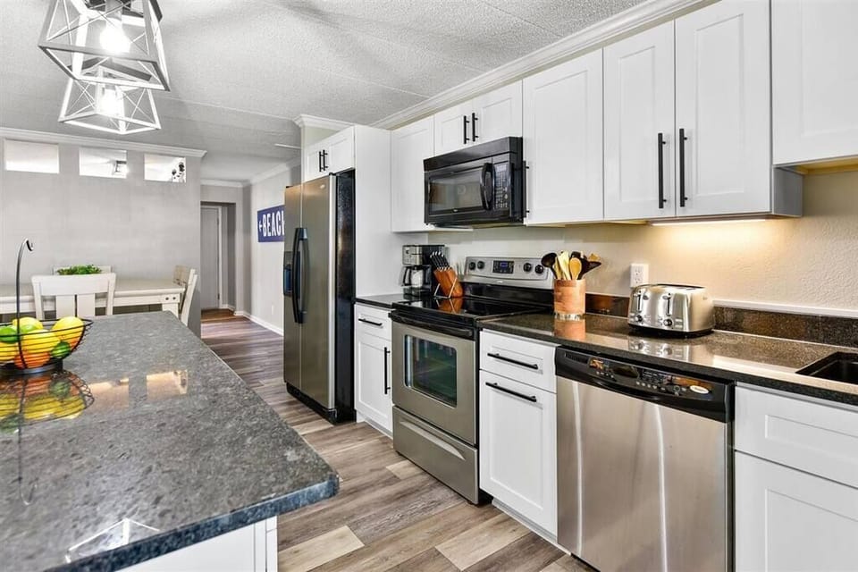 “Bright kitchen stocked with everything you need for family dinners or quick snacks