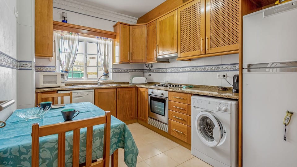 Practical kitchen, equipped with everything you might need during your stay, including a washing machine, a dishwasher and an oven+stove, as well as a small siting area #traditional #lovely