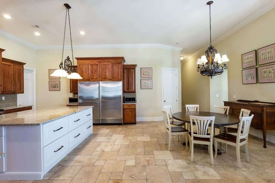 - Experience the seamless flow of our open kitchen and dining area of the home in Naples, Florida
- Gather for meals and make memories in our spacious dinning area
- Cook in style in our open kitchen fully equipped with modern appliances