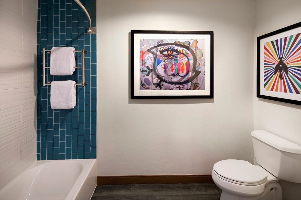 Refresh after adventures with bright tile, deep tub, and plush towels.