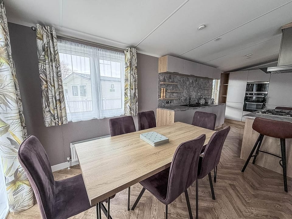 Situated conveniently opposite the kitchen, this dining table is the ideal spot for sharing meals, playing board games, or simply planning your next day's adventure on the Norfolk coast.