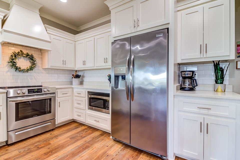 Fully stocked kitchen with stainless appliances and charm.