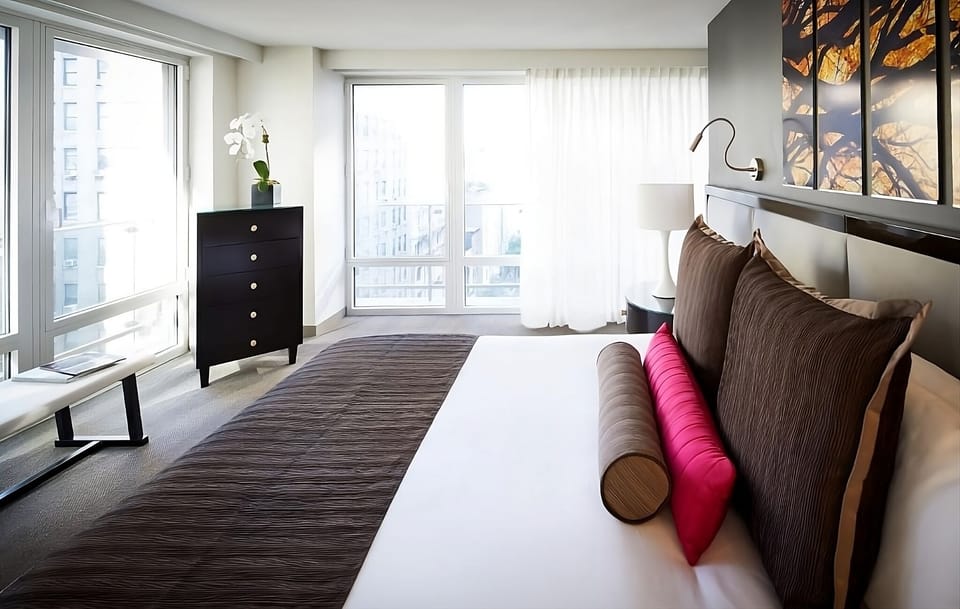 Wake up to bright city views from a plush king bed