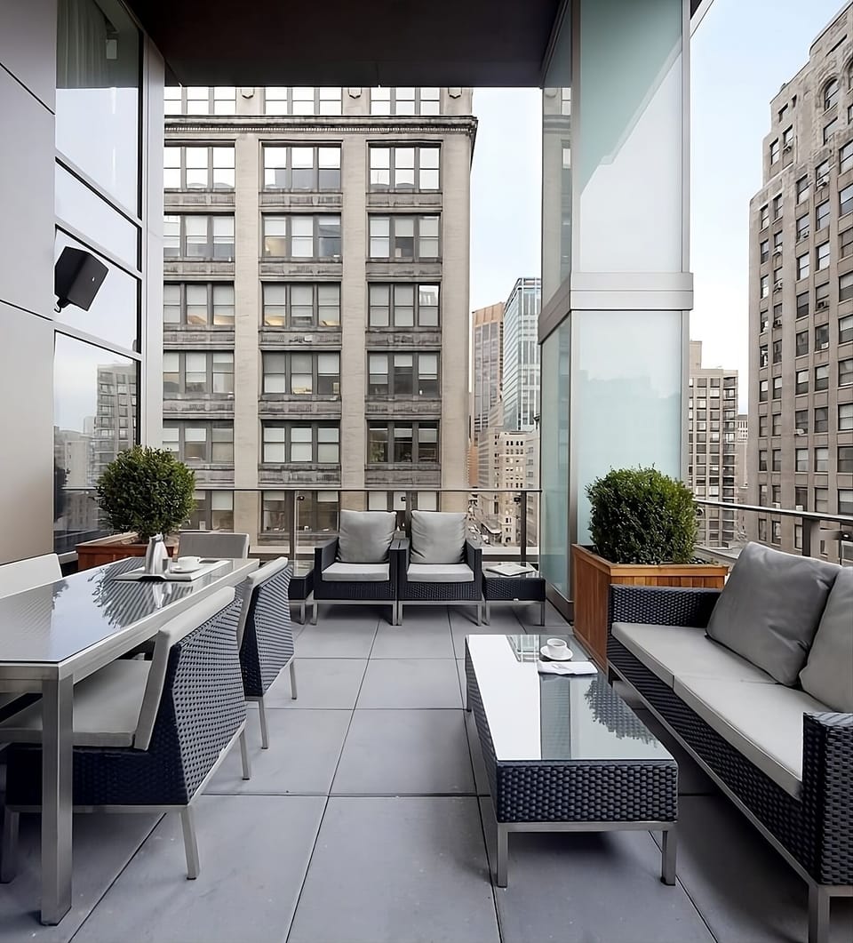 Lounge outdoors on cushioned seating with skyline backdrops.