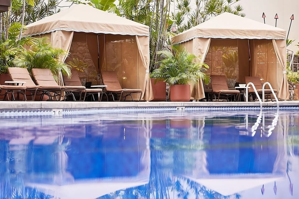 Lounge in shaded cabanas and savor poolside calm.