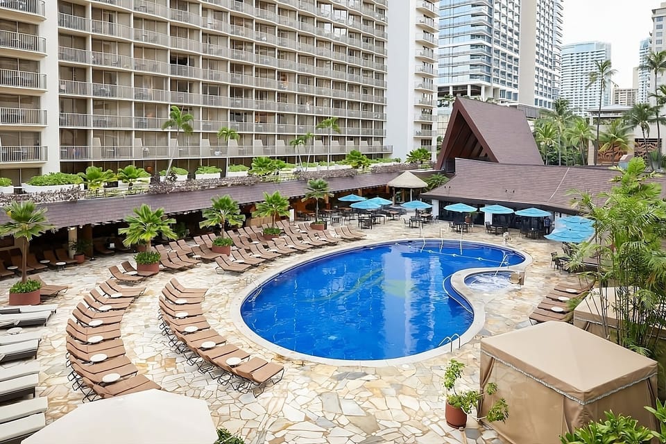 Dive into the resort-style pool surrounded by loungers.