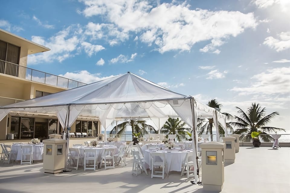 Celebrate under a breezy tented terrace with ocean backdrop.