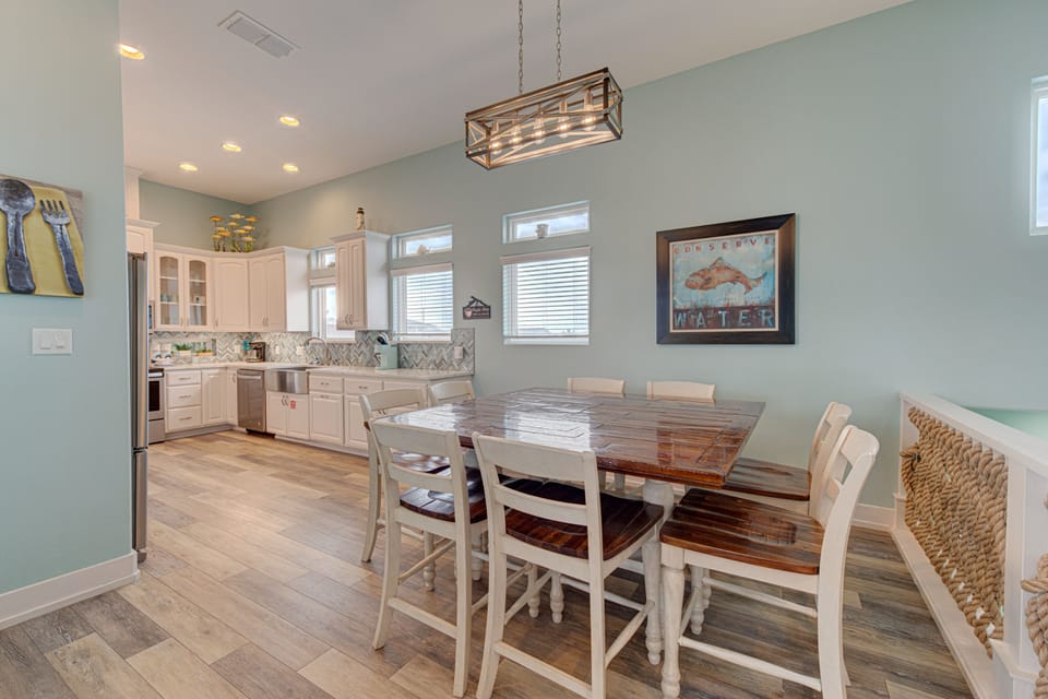 Gather around your beautiful farmhouse dining table in this open kitchen space, where soft mint walls and rustic charm create the perfect backdrop for memorable meals.