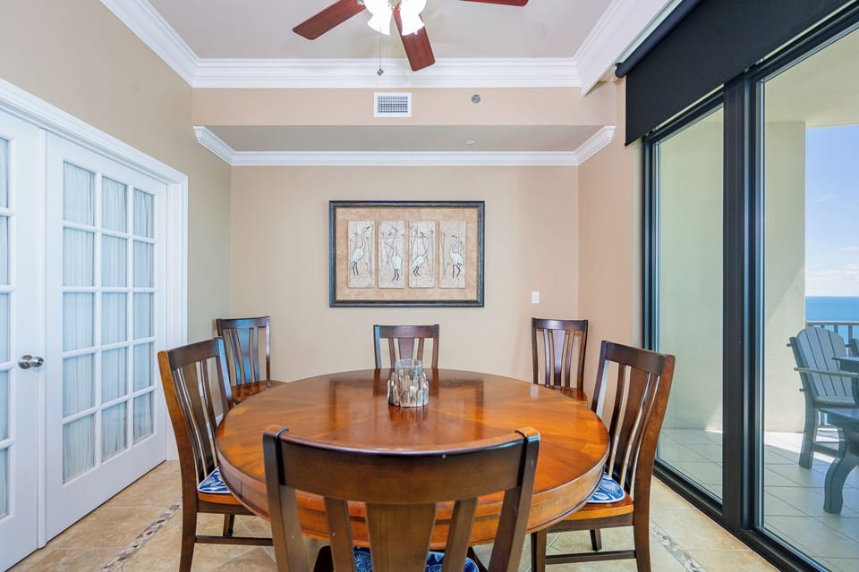 Savor heartfelt conversations at the round dining table while admiring the beach view through the large windows