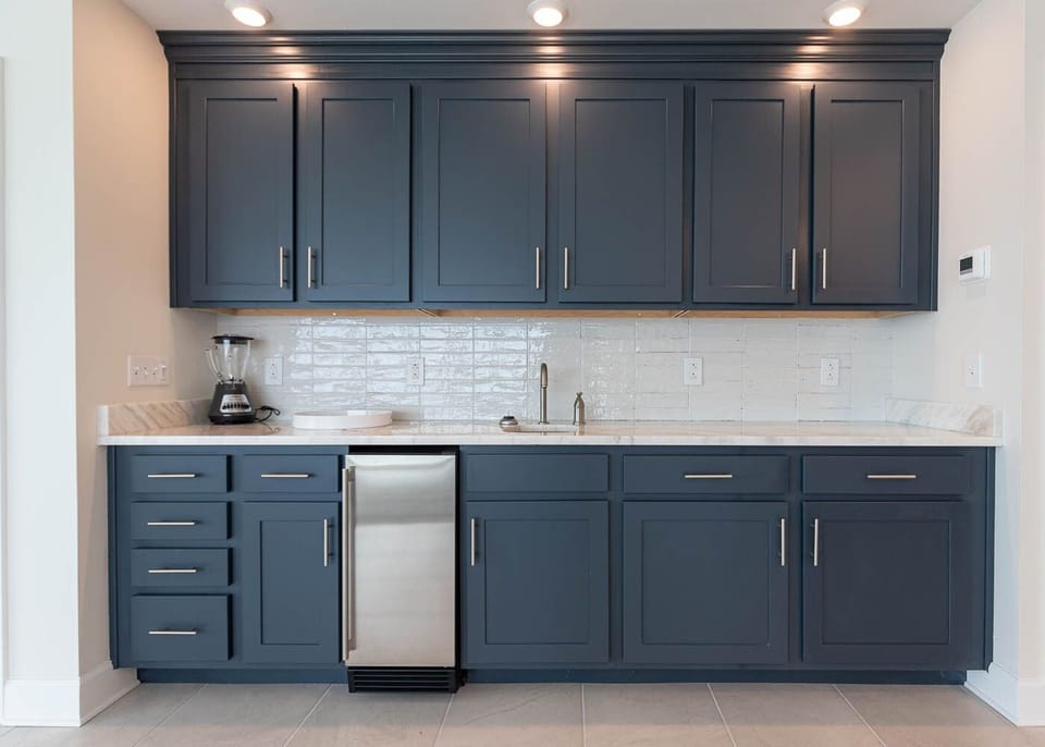 Mix chilled drinks at the wet bar using the undercounter fridge, sink, and ample counter space