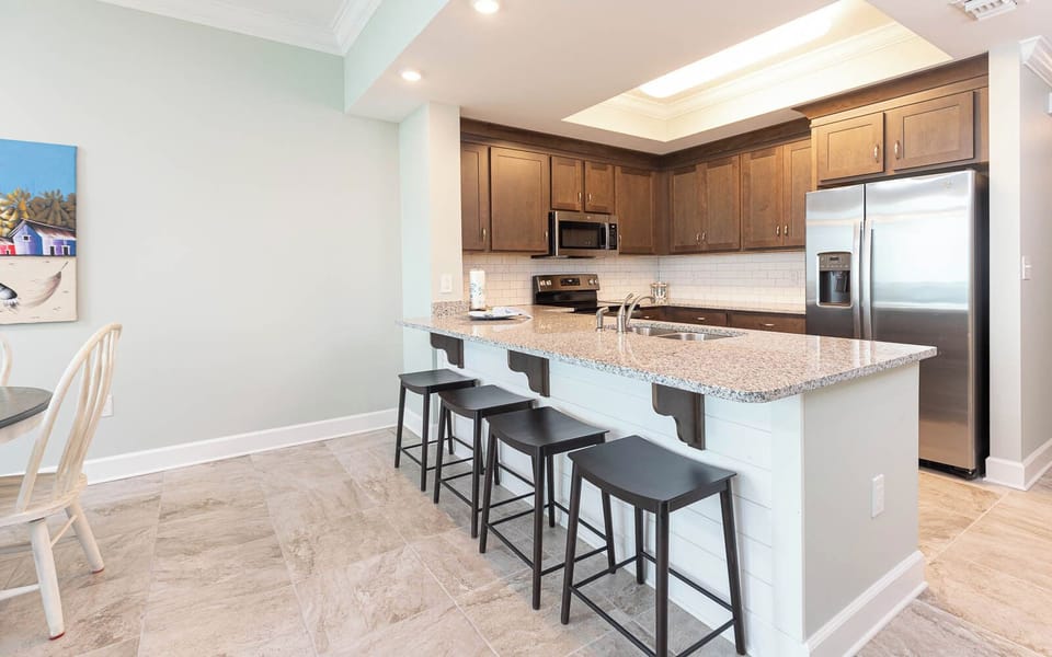 Pull up a stool at the breakfast bar and savor your morning coffee in this inviting kitchen space