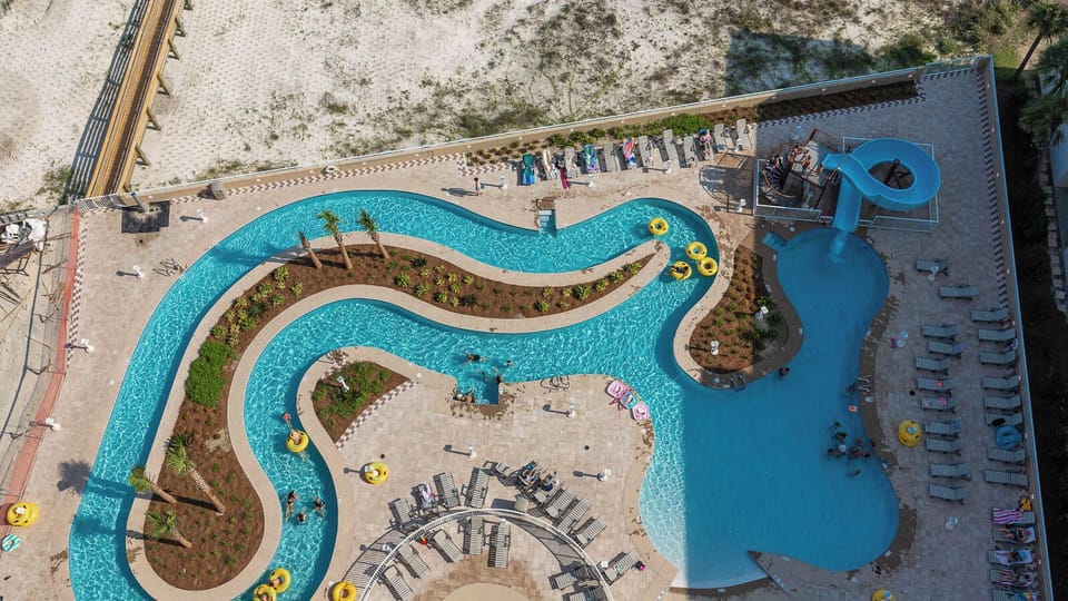 Float on a yellow tube down the lazy river and experience the thrilling waterslide, just steps from the beach