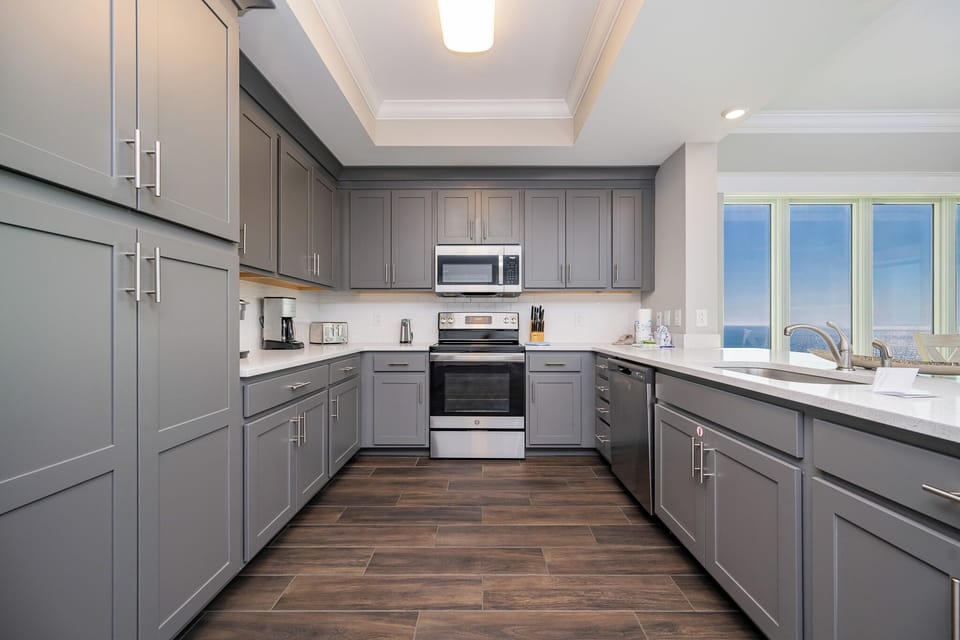 Admire the beach from the kitchen and prepare meals with spacious counters, stainless appliances, and sleek cabinetry