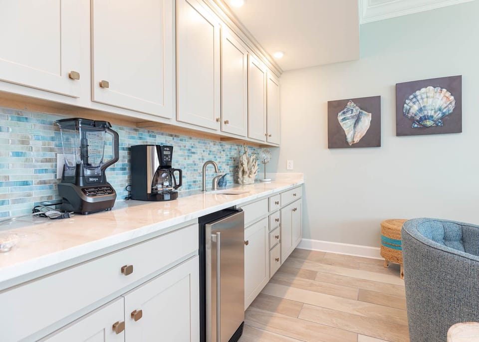 Enjoy coffee and mix drinks at the wet bar while admiring coastal artwork and stylish accents