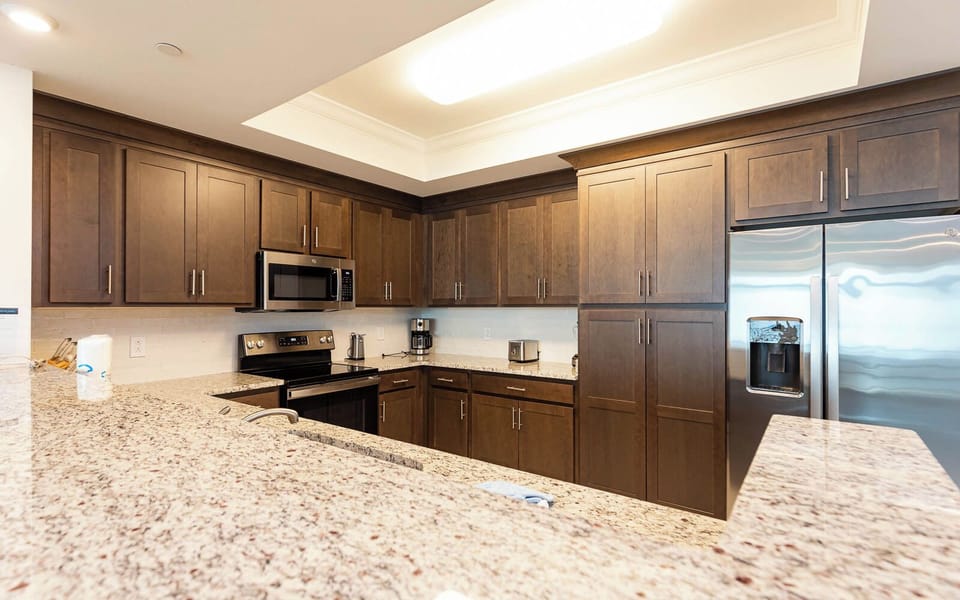 Imagine prepping breakfast at the long counter with stainless appliances and ample cabinetry