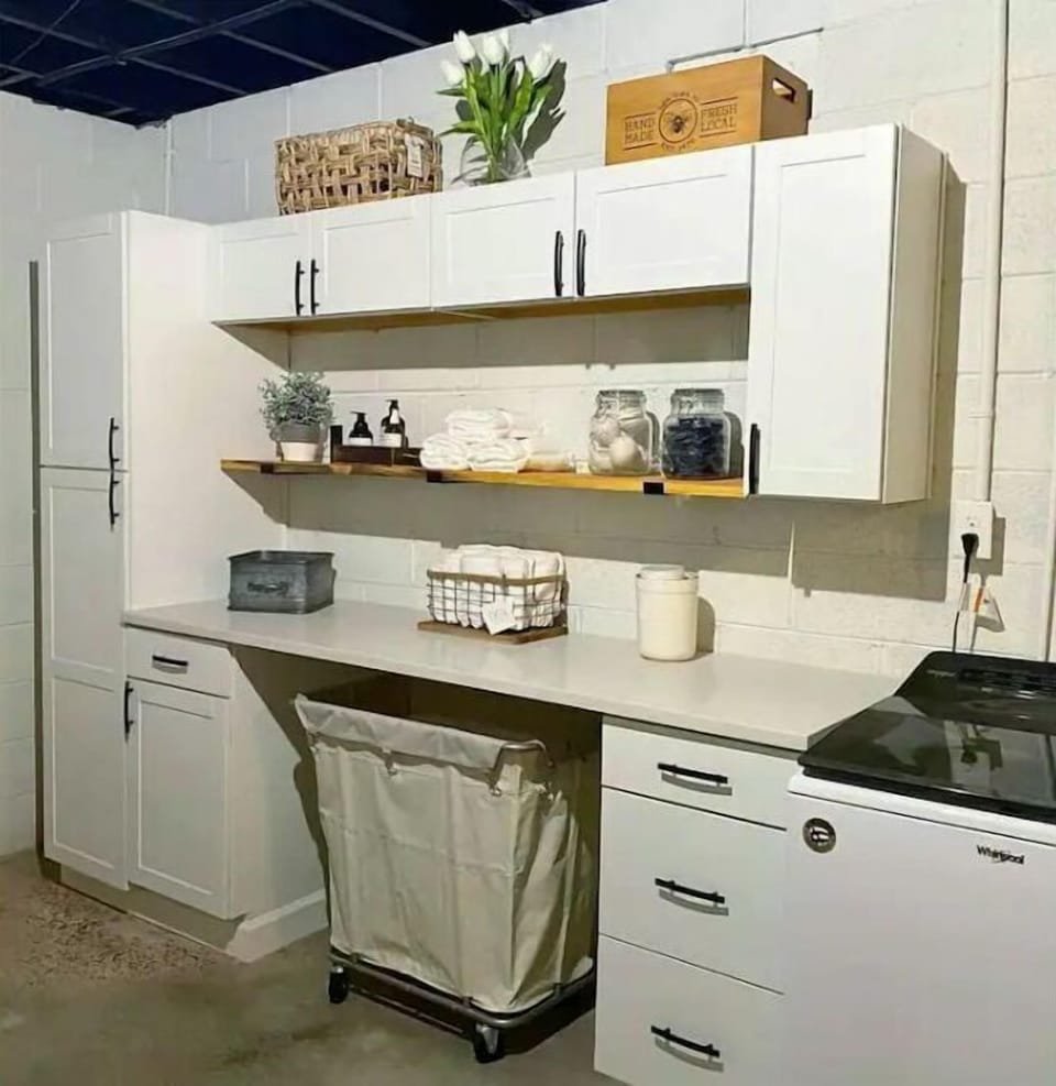 Finished space on ground level w/laundry room, sink, coffee bar and microwave.