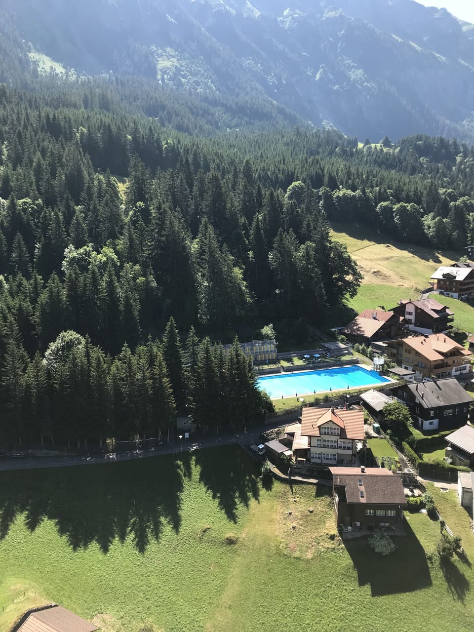 View of Wengen outdoor pool from cable car 