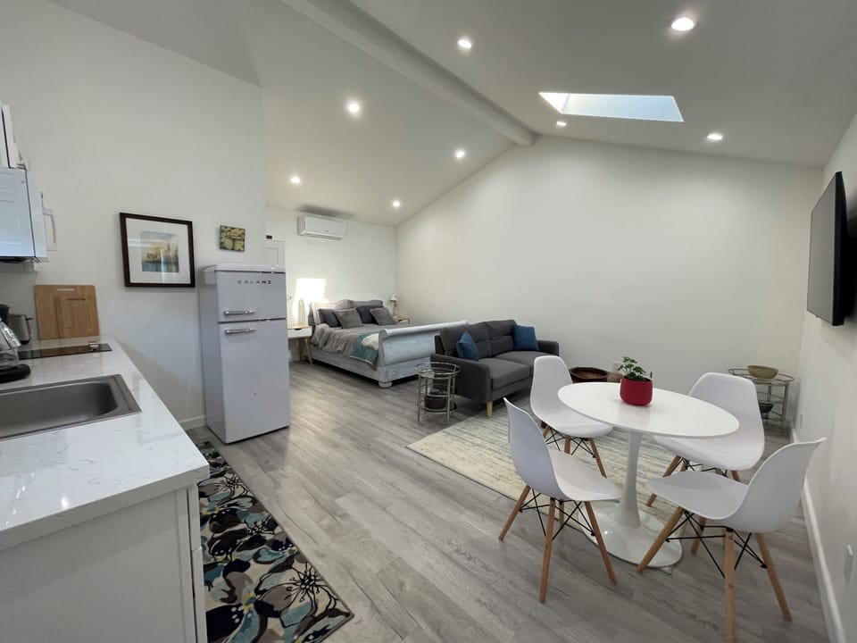 Bright room with skylight and dimmable overhead lights. Desk not in photo.