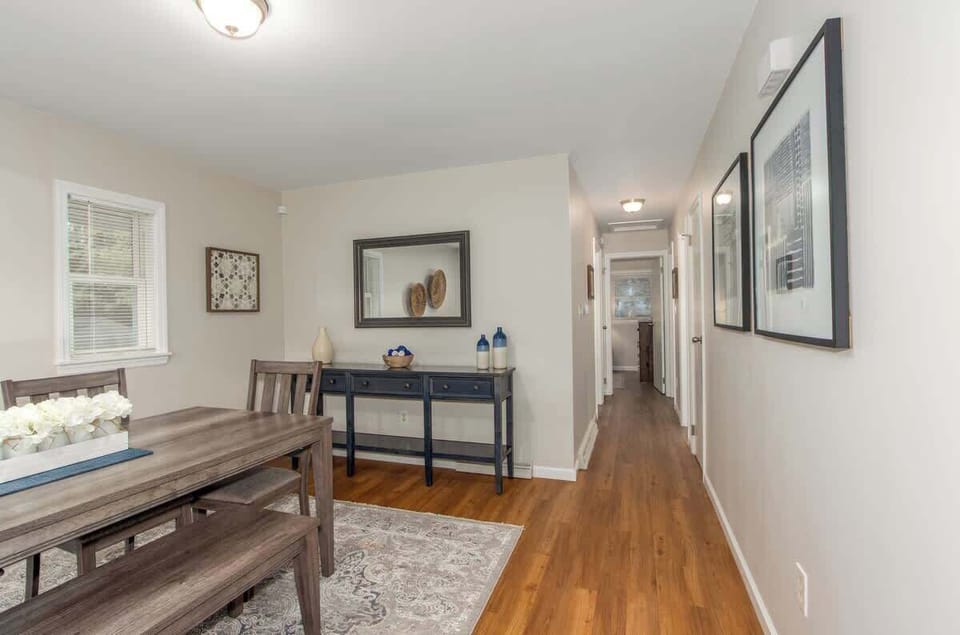 The dining room sits just off the hallway leading to the bedrooms and a bathroom, creating an easy, functional layout that keeps the home’s gathering spaces connected while still providing separation from the sleeping areas.