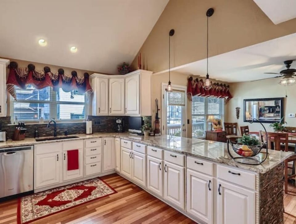 Fully stocked kitchen with bar seating off dining area
