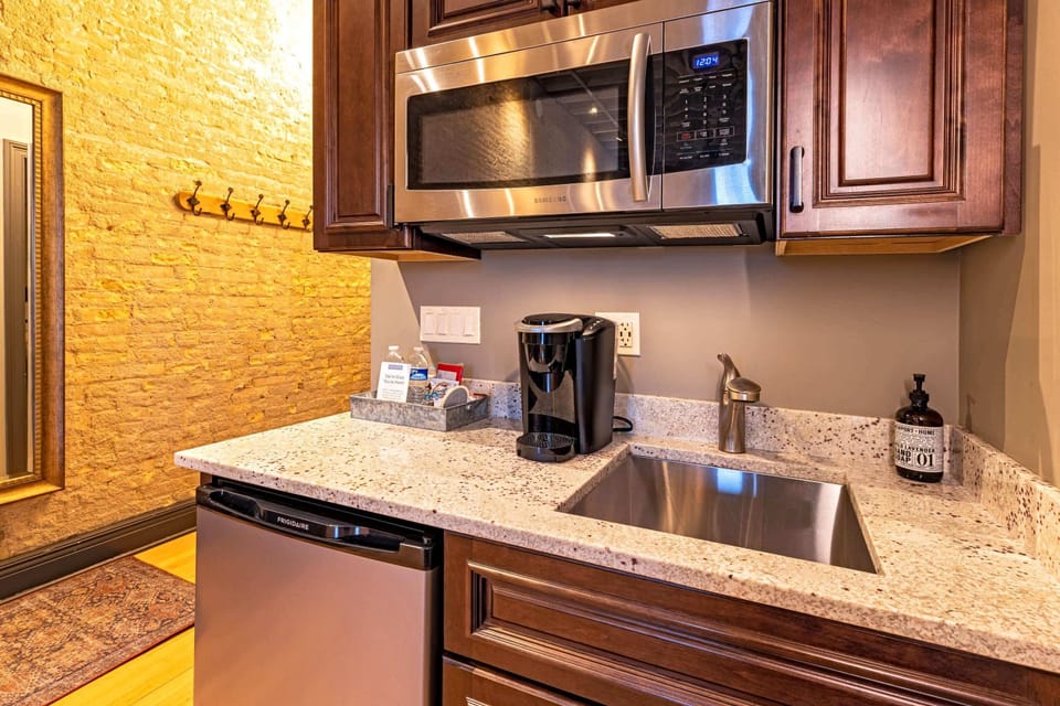 Granite counters, Keurig, microwave, and mini fridge — the kitchenette is compact and fully equipped.