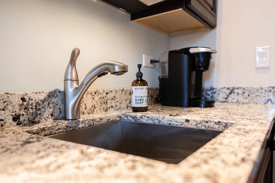 Undermount sink, granite countertops, and a full coffee setup. The small details are done right.