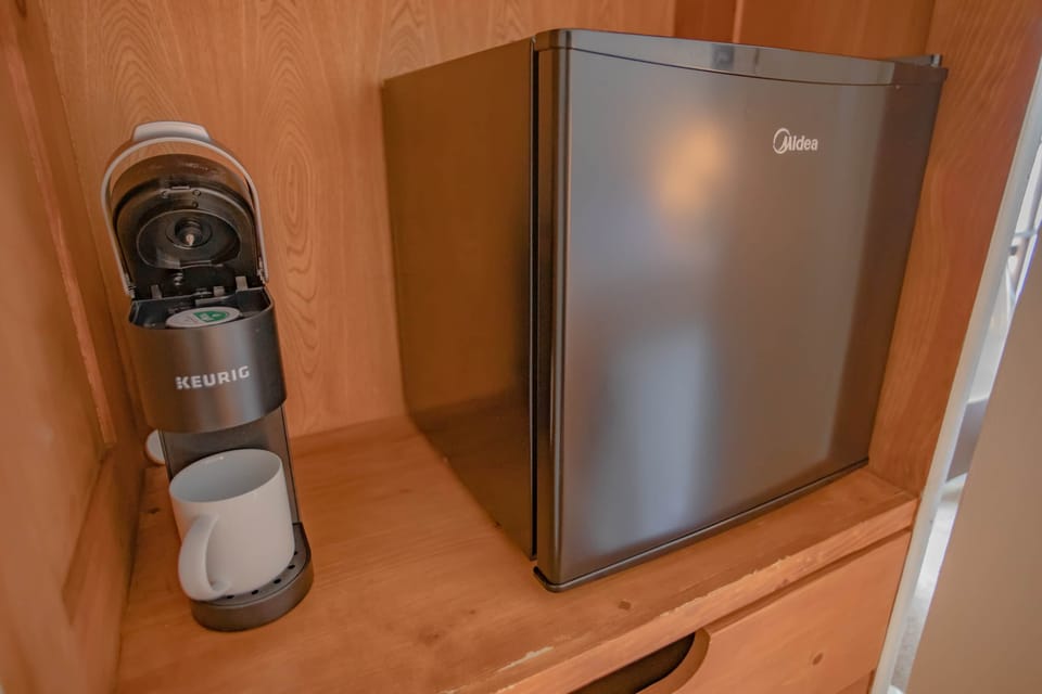 Coffee maker and mini fridge.