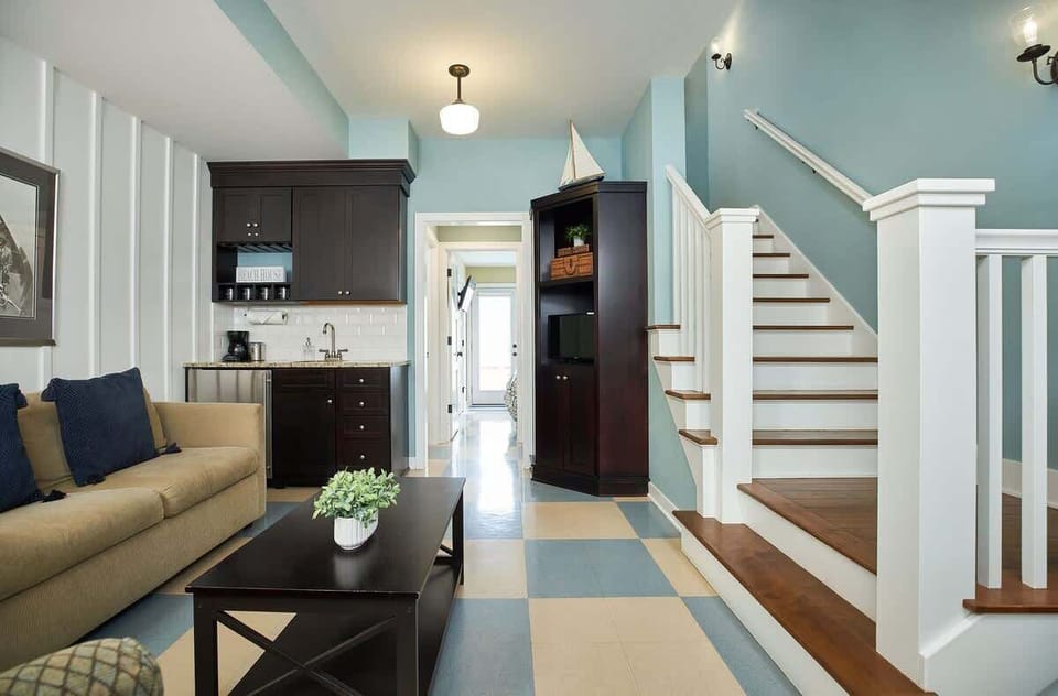 First floor entry point, half kitchen, seating area, full bathroom and queen bedroom