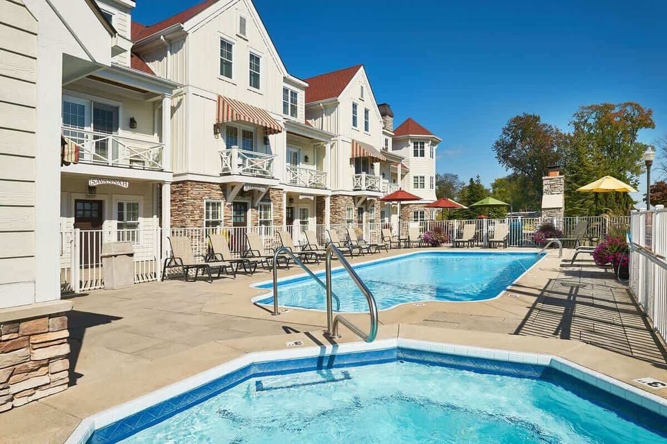 Swimming pool and spa area with seating 