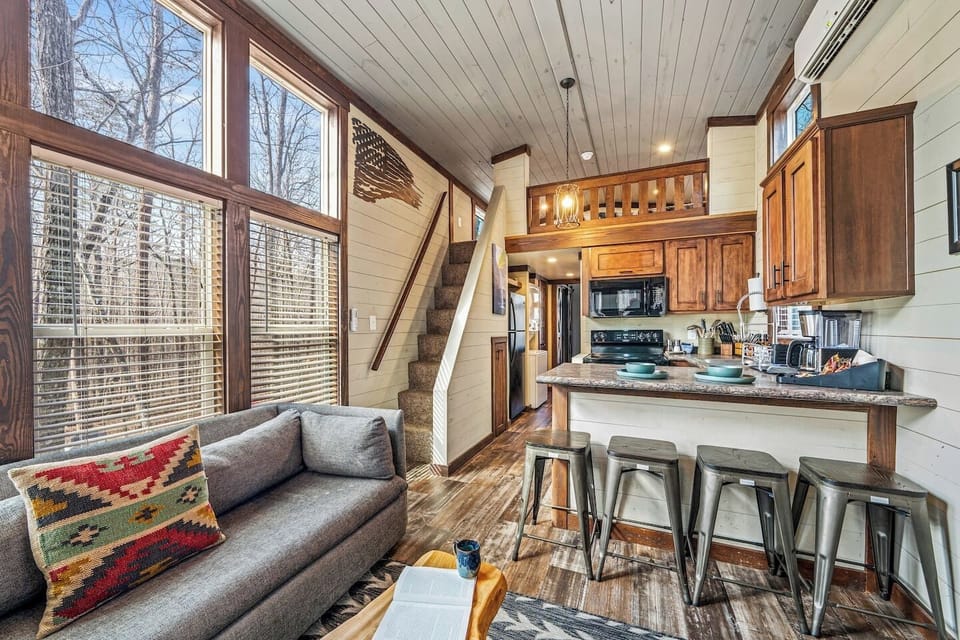 Dining area with three bar stools and a charming view of the loft.