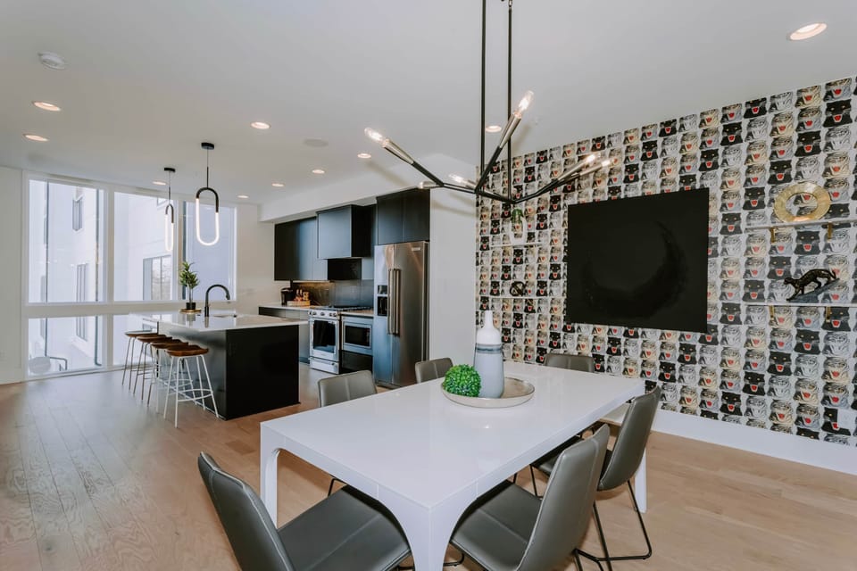 Have a snack at the island or sit back and relax at the modern dining table.
