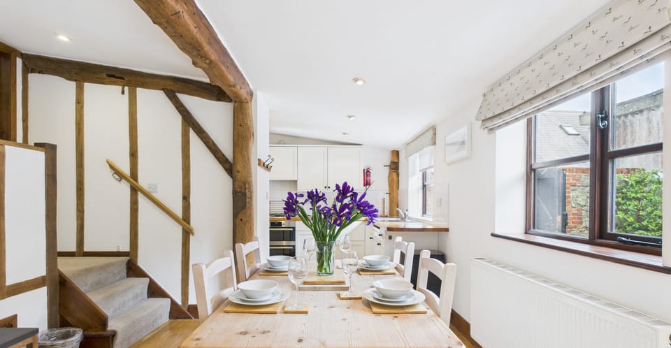 Well-equipped kitchen and dining table at The Cote, ideal for social cooking and meals during your countryside holiday.