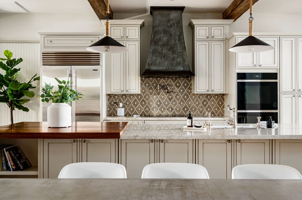 The kitchen has double ovens, a large island prep station, and water pot filler.