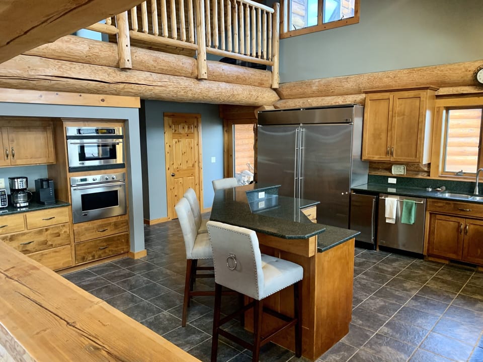 Huge kitchen with high ceilings. Open loft with 3 queen beds is overhead. 