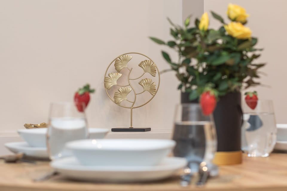 A beautifully set dining table with fresh flowers, creating a welcoming atmosphere.
