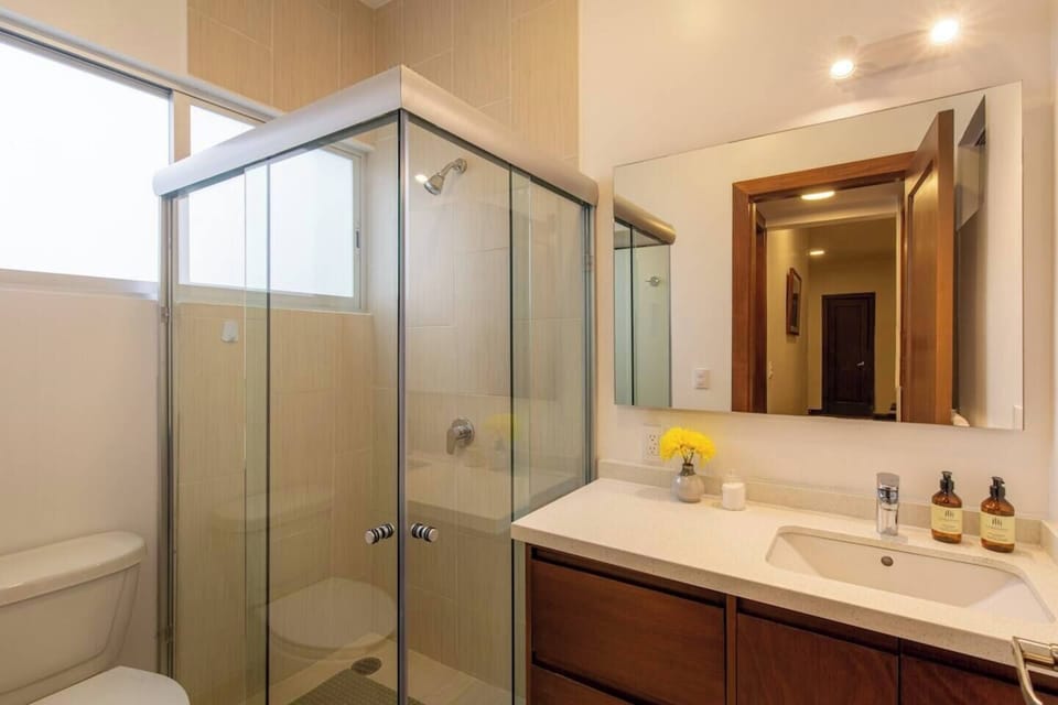 Enjoy the luxury of a larger glass door shower and the plushness of our soft towels in this inviting bathroom