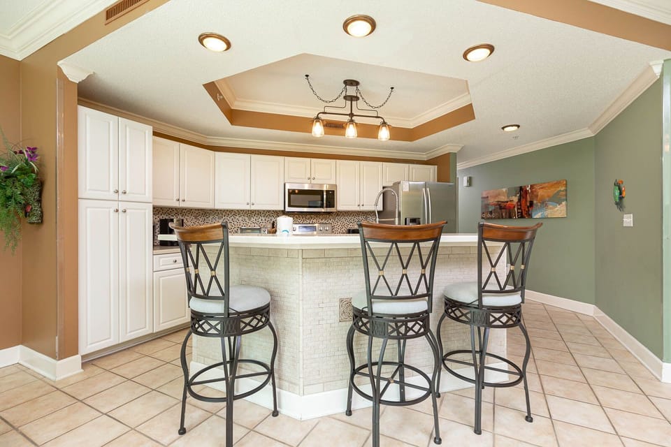 Gather with friends at the sleek breakfast bar, enjoying laughter and conversation in this inviting kitchen space