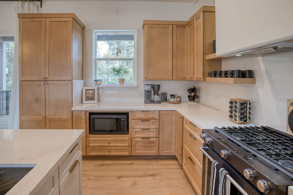 Our kitchen features upgraded appliances & cabinetry and pantry storage, 