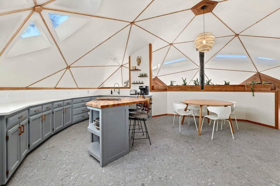 Complete with a geometric butcher block island and seating for 6.