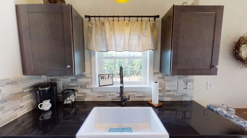 You’ll find a farmhouse sink and plenty of prep space on the countertops, along with all the cookware, bakeware, dishware, flatware, glassware, serving-ware, and utensils you need to prepare and serve your favorite meals.
