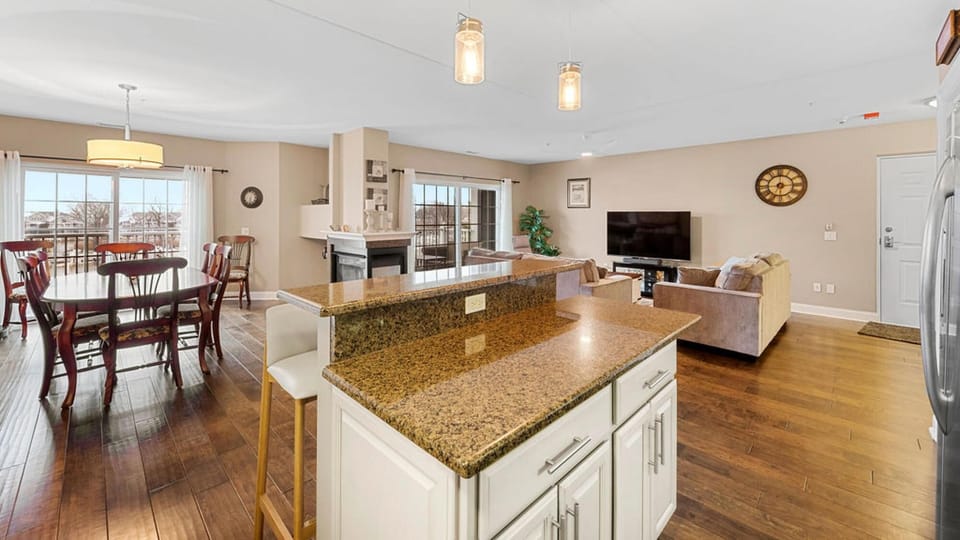 Kitchen and living area with warm hardwood floors