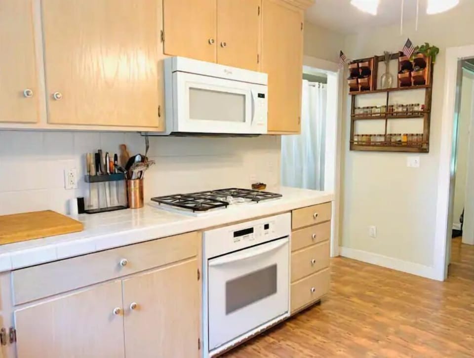 The kitchen is stocked with supplies including crockpot, instant pot, & spices