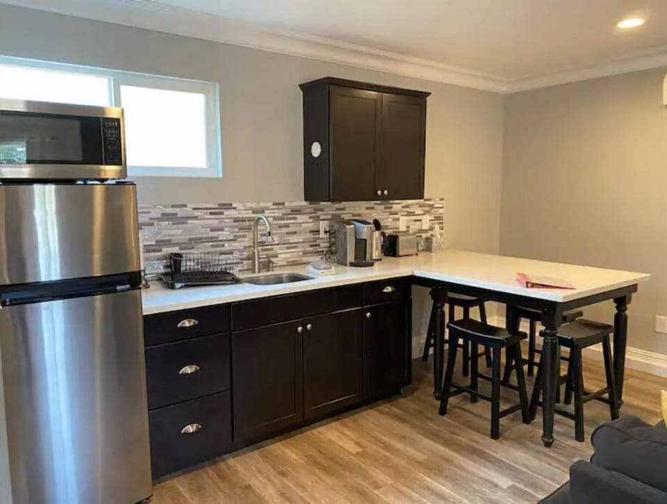 Kitchenette with Keurig coffee maker, kettle, toaster, microwave, fridge