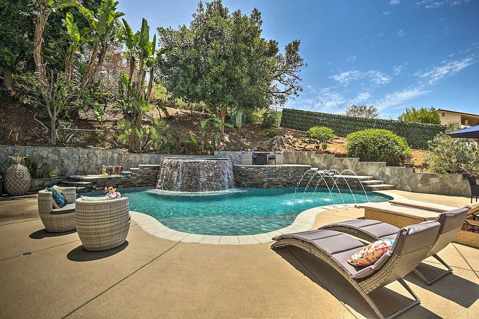 Sun-soaked poolside escape with waterfall, fountains & loungers!
