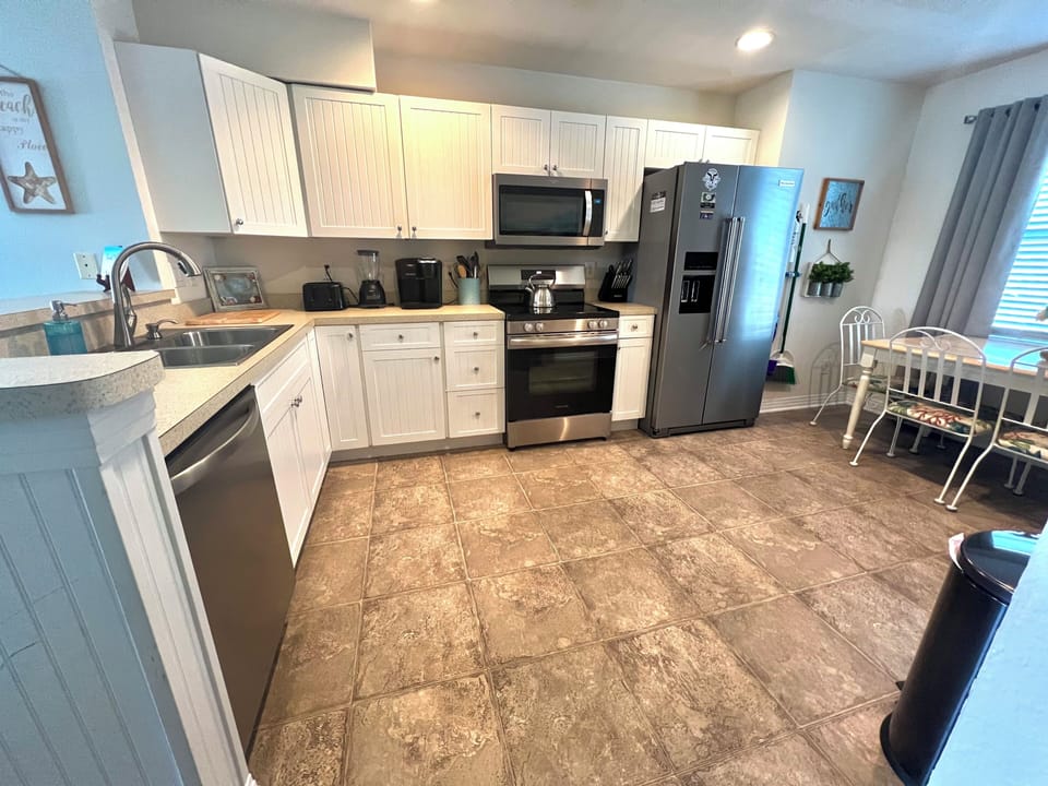 Open kitchen with new stainless steel appliances