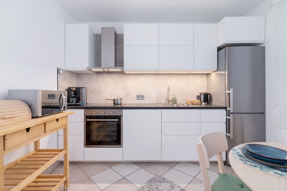 Another perspective of the kitchen, highlighting its sleek and functional design.
