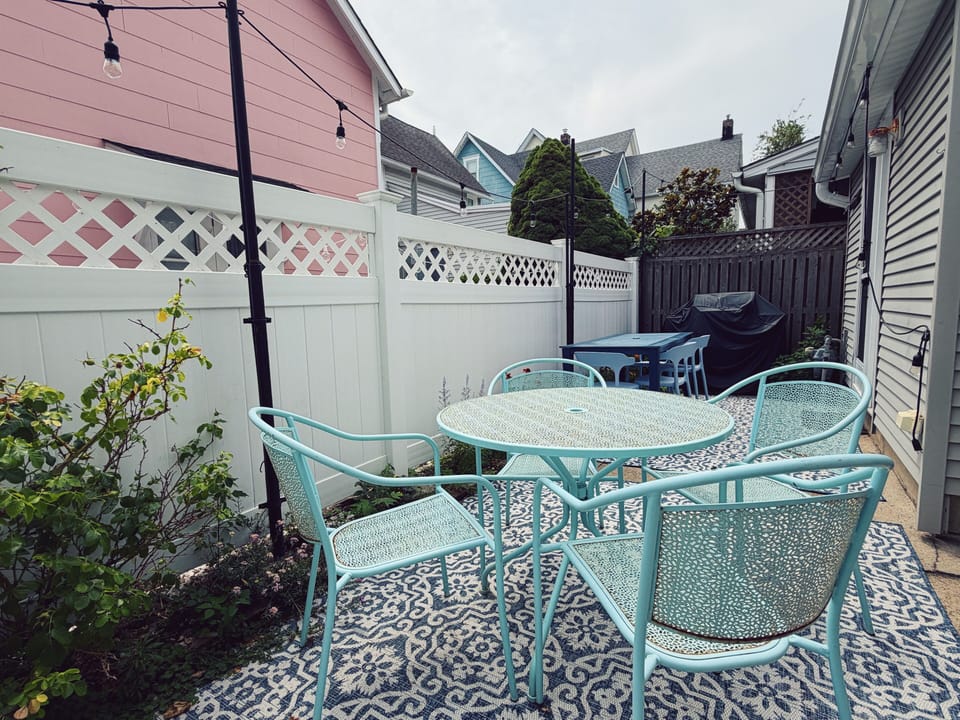 Sunny back patio with Weber grill.